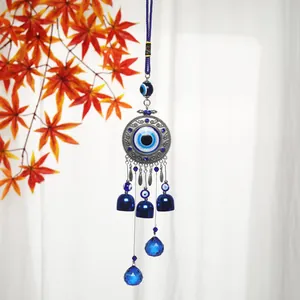 Detailed view of Turkish Evil Eye hanging ornament with blue bells and crystals