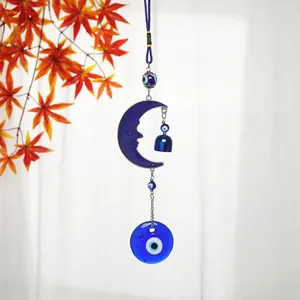 Detailed view of bohemian blue evil eye crescent moon hanging decor with blue glass beads