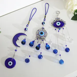 Set of three Turkish evil eye crystal hangings with blue glass beads and silver bells