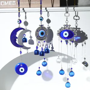 Close-up detail of handmade evil eye hanging ornaments with blue crystals and metal bells