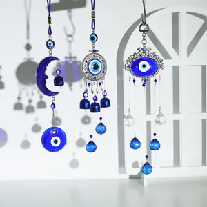 Detailed view of diverse Turkish blue evil eye hanging ornaments with crystals and bells