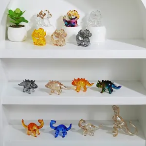 Variety of colorful crystal glass dinosaur and mythical creature figurines on display