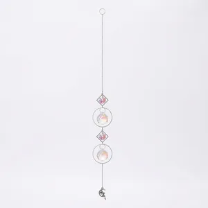 Detail of silver crystal suncatcher with geometric frames and fairy moon pendant.