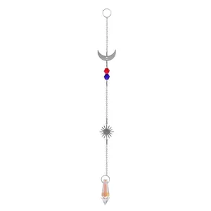 Close-up of silver suncatcher with moon and sun charms, red and blue beads, and crystal prism