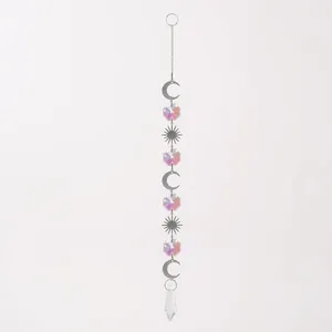 Detailed view of iridescent suncatcher hanging ornament with silver crescent moons and suns