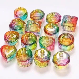 Various rainbow gradient glass dappen dishes and jewelry boxes with lids for nail art storage.