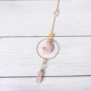 Detailed view of handmade pink crystal moon and star suncatcher hanging ornament
