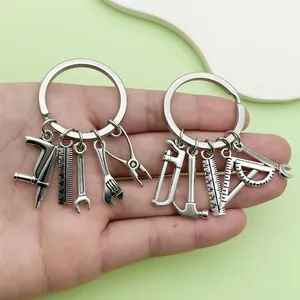 Silver tool keychain with miniature hammer, saw, and wrench charms for Father's Day