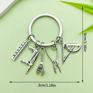 Macro detail view of silver tool keychain with dimensions showing 6cm by 3cm measurements