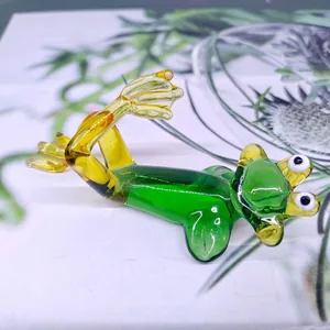 Detailed view of a handcrafted green and yellow glass frog figurine for home decor.