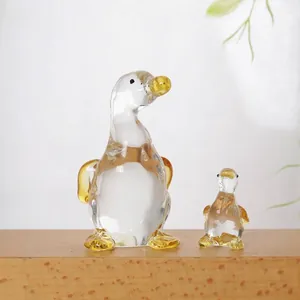 Detailed view of handcrafted crystal glass duck mother and child figurines