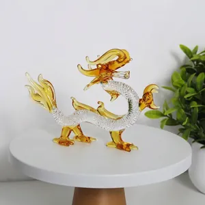 Macro view of detailed amber and clear crystal dragon figurine on a white stand