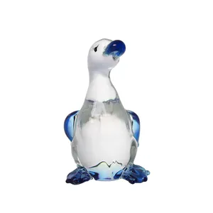 Detailed view of a hand-blown glass duck figurine with blue accents for home decor