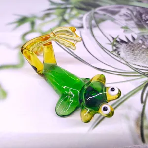 Detailed shot of a hand-blown green glass frog figurine in a quirky lying pose for decor