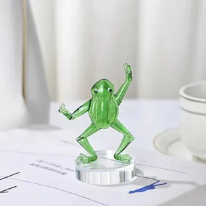 Macro view of a handcrafted green glass kung fu frog figurine on a clear crystal base