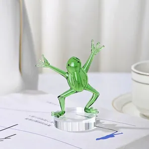 Detailed view of a green glass kung fu frog figurine ornament on a clear base