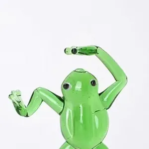 Close-up detail of a green hand-blown glass frog figurine in a kung fu standing pose