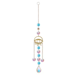 Macro detail of a golden evil eye sun catcher featuring iridescent crystal prisms and waterdrop pendant