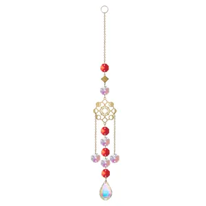 Detailed macro view of a gold snowflake crystal suncatcher with red and AB beads.