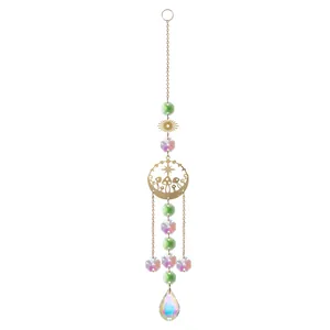 Macro view of iridescent crystal teardrop and gold mushroom disc suncatcher