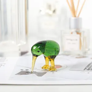 Handcrafted green glass kiwi bird figurine on a modern desk for home decoration