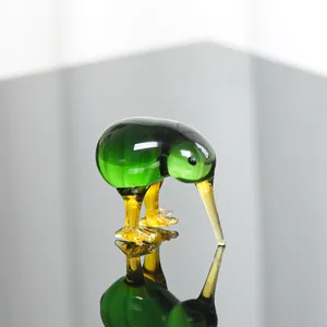 Detailaufnahme einer handgefertigten grünen Glas-Kiwi-Figur mit reflektierender Oberfläche.