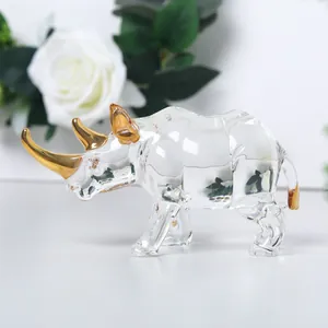 Elegant clear glass rhinoceros figurine with decorative golden horns for luxury home decor