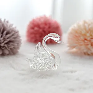 Detailed macro view showing the textured body of a clear faceted crystal swan figurine.