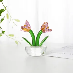 Close-up view of elegant pink crystal tulip flowers in a faceted clear glass base