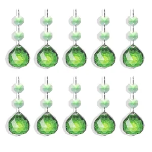 Set of 10 emerald green crystal teardrop pendants for chandelier and home decor.