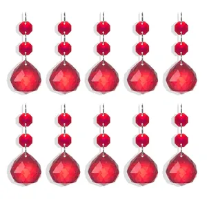 Close-up detail of faceted red glass crystal drop pendants for decorative home lighting.