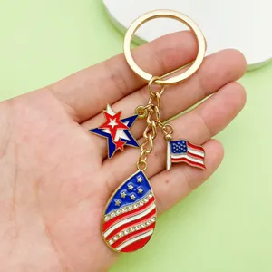 Close-up of patriotic USA flag and star charms with rhinestones on a gold keychain