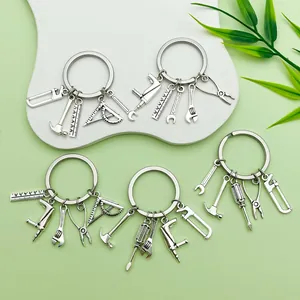 Detailed macro view of five silver keychains featuring assorted miniature tool charms