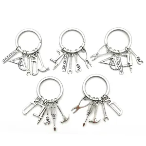Detailed view of silver tool keychains featuring hammers, saws, and wrenches for Father's Day.