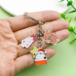 Detailed view of Christmas charms featuring Santa and a gingerbread man on a keychain