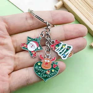 Detailed view of festive metal enamel keychain charms featuring Santa Claus and reindeer