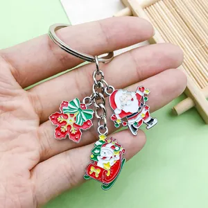 Close-up of cute cartoon Santa Claus, snowman, and snowflake charms on a silver keychain