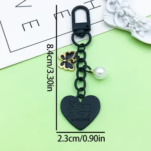 Detailed view of heart keychain with size measurements in cm and inches.