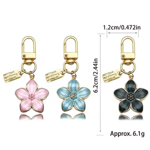 Three-color five-petal flower keychains in pink blue black with size 6.2cm