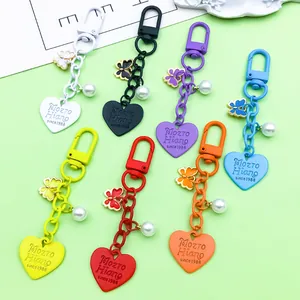 Colorful heart and butterfly charm keychains with pearl accents in multiple vibrant colors.