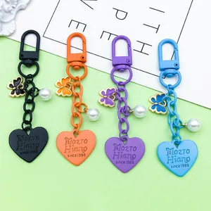 Set of colorful zinc alloy keychains with heart tags, butterfly charms and pearls