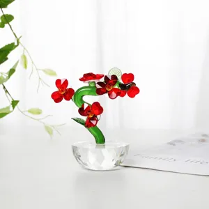 Detail view of red heart-shaped crystal flowers with green stem on faceted base
