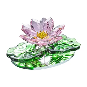 Elegant purple crystal lotus flower ornament with green lily pads on a transparent base