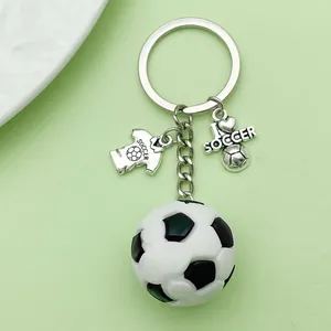 Close-up detail of the creative PVC soccer ball keychain with silver metal charms