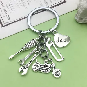 Close-up detail of silver Father's Day keychain with mini tool charms and dad heart pendant