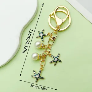 Handmade starfish and pearl keychain with gold-plated finish, 4.33 inches total length