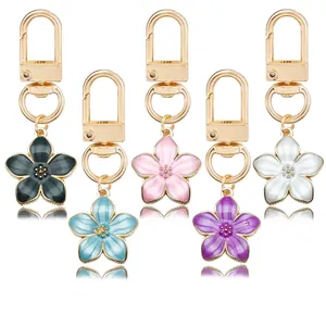 Set of colorful pearlescent enamel cherry blossom keychains with elegant gold clasps