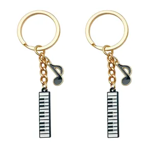 Detail view of gold musical keychains featuring piano keys and eighth note charms