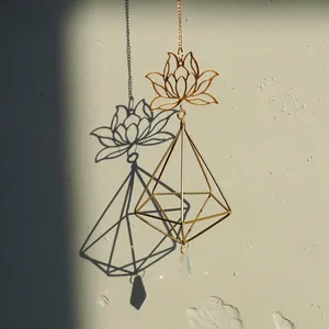 Detailed view of a golden lotus suncatcher with geometric frame and crystal prism