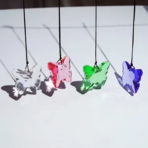 Detailed view of colorful butterfly crystal sun catcher pendants with faceted edges